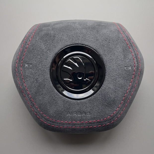 Gray Alcantara airbag cover with red stitching Skoda Fabia IV Octavia IV front view